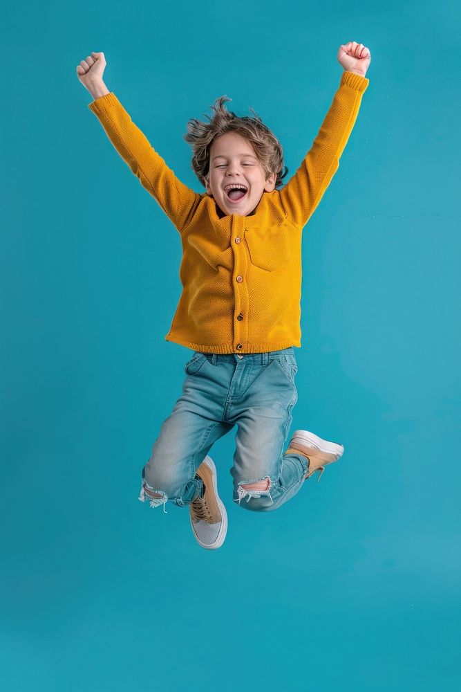 Boy is jumping triumphant clothing apparel.
