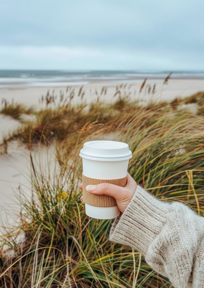 Coffee cup mockup beach ocean hand.