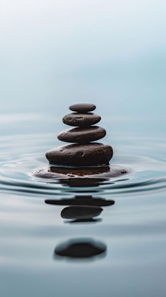 Stack of smooth stones water medication outdoors.