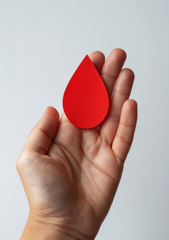 Hand giving paper red drop shape plectrum symbol racket.