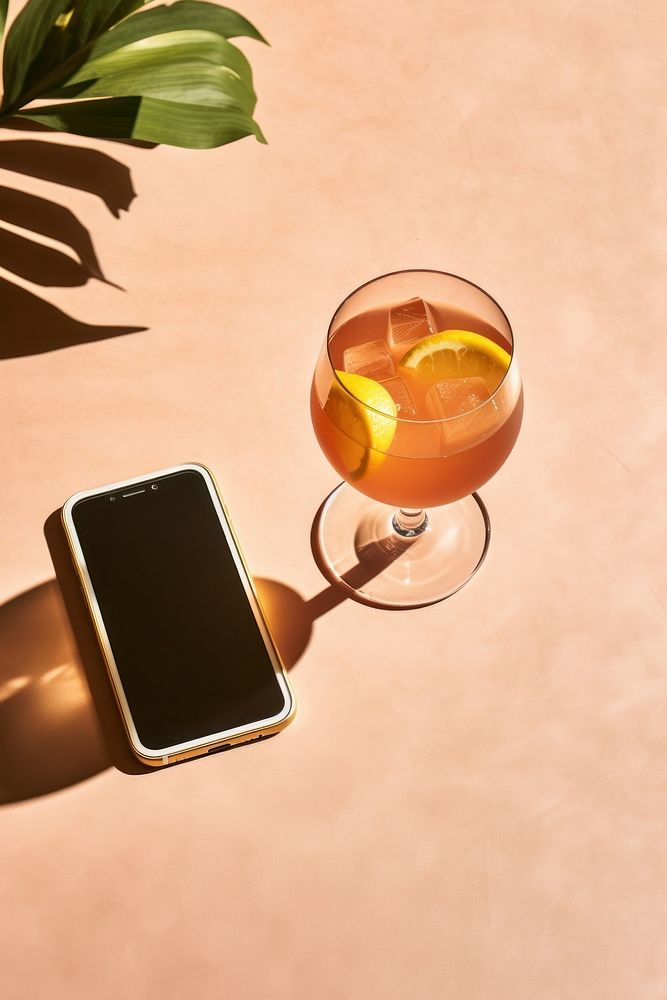 Smartphone on glass-table electronics beverage alcohol.