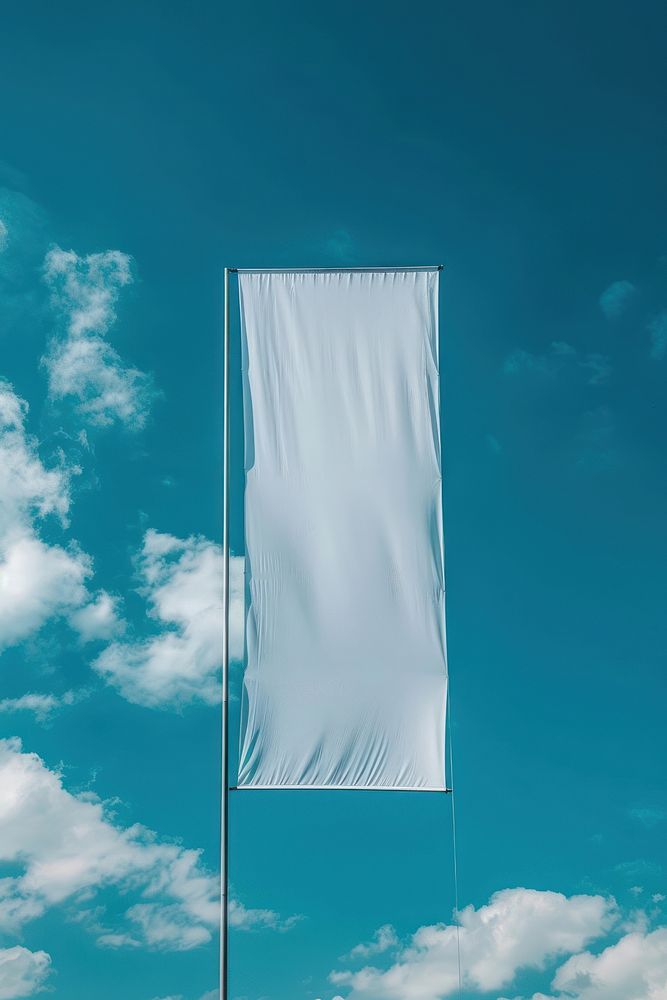 Empty white vertical banner against blue sky without clouds flag.