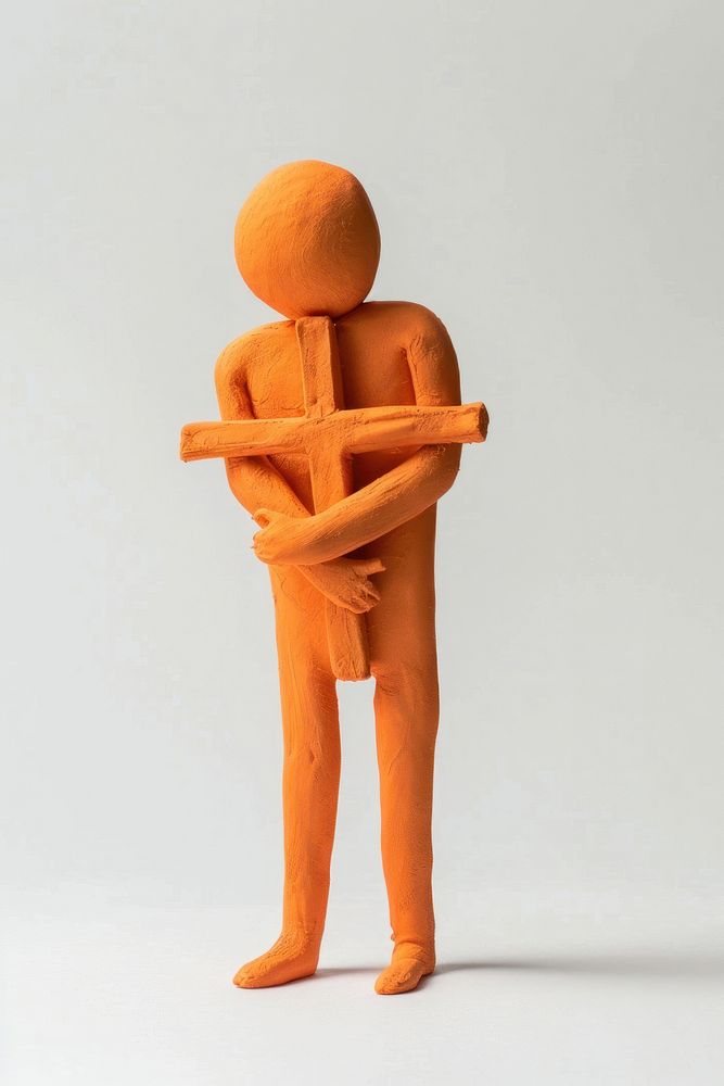Man holding cross sculpture figurine person.