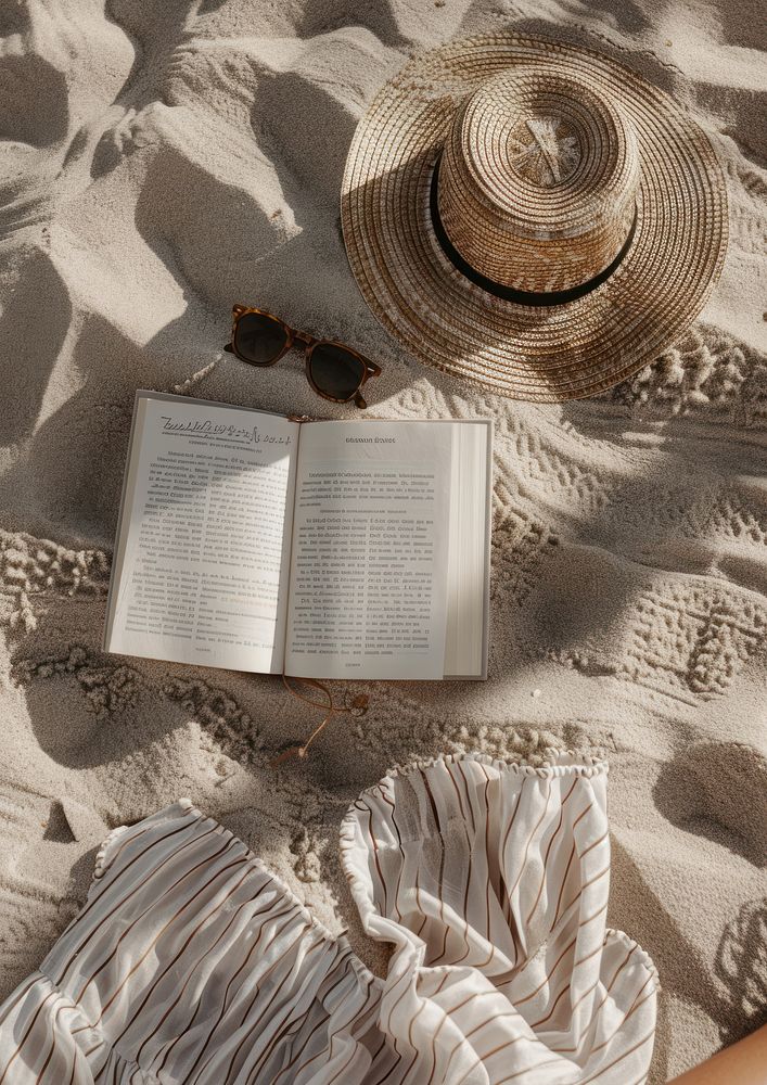 Open book on the sand glasses hat publication.