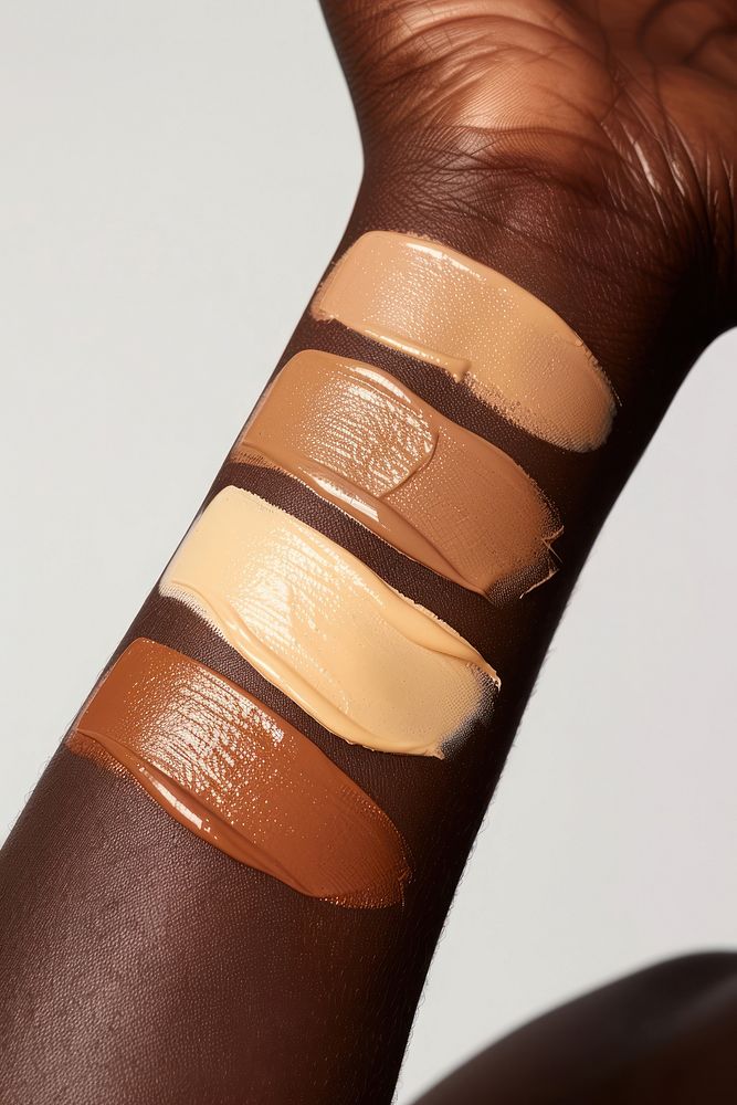 Liquid face foundation swatch in 3 shades of skin tone colors bandage person human.