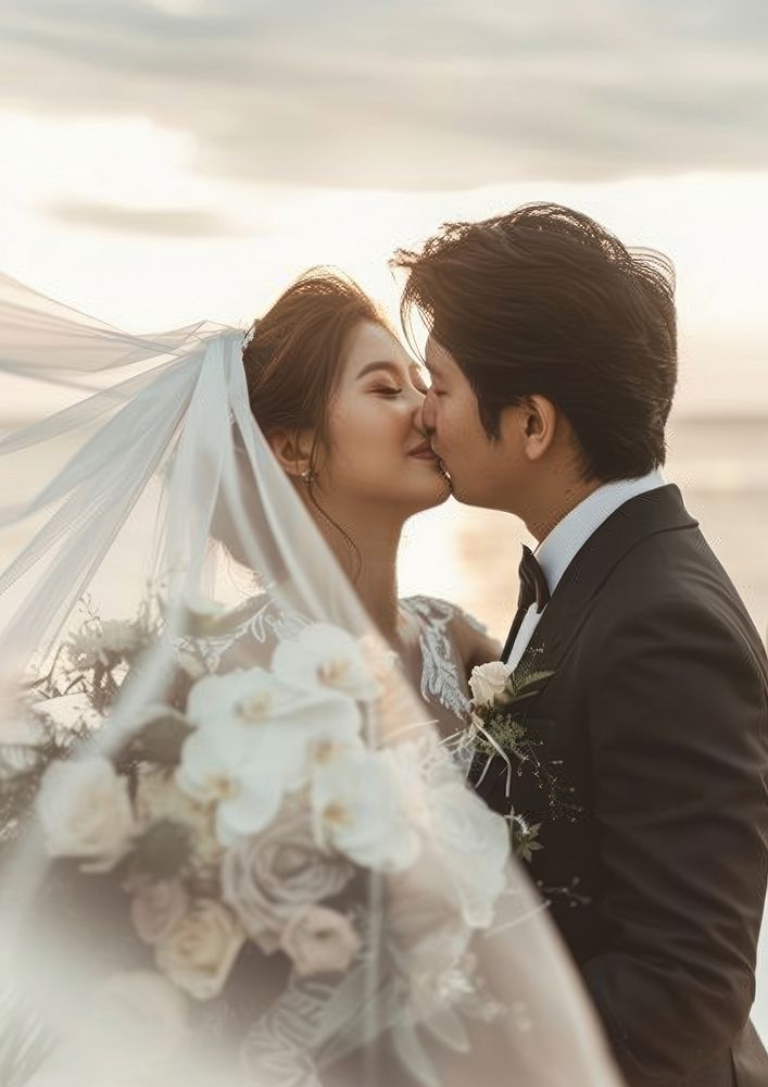 Southeast Asian groom wedding kissing bridegroom.