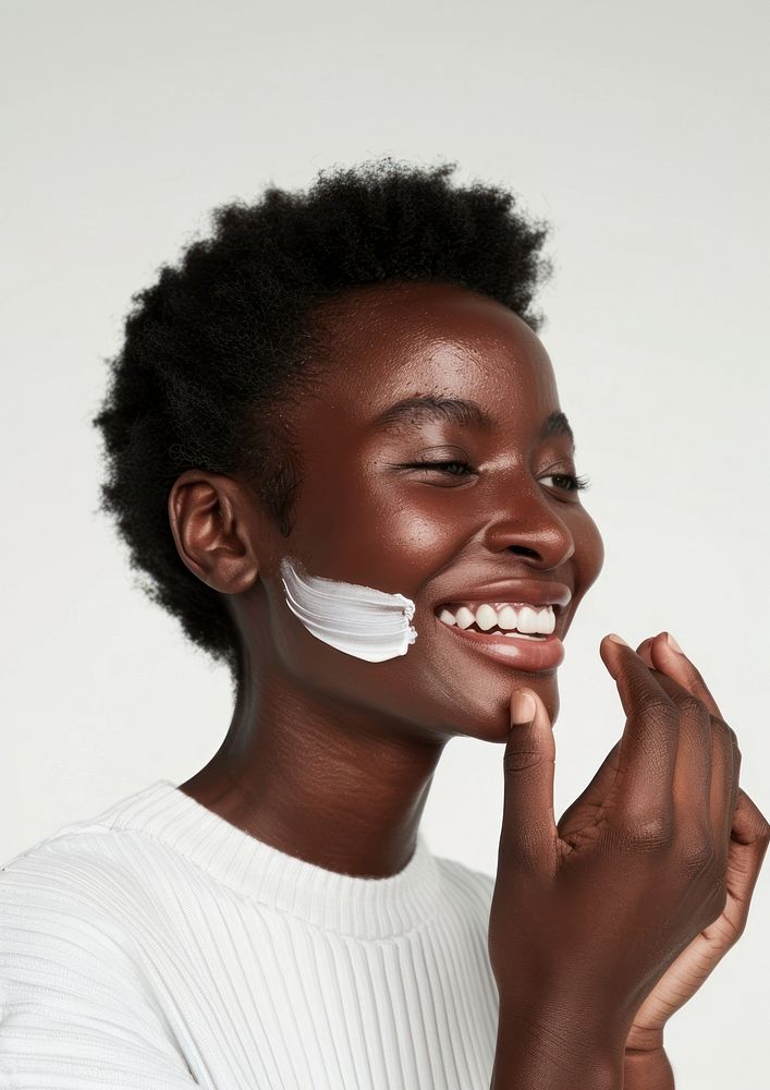 Woman applying cream on her face photography smile portrait.