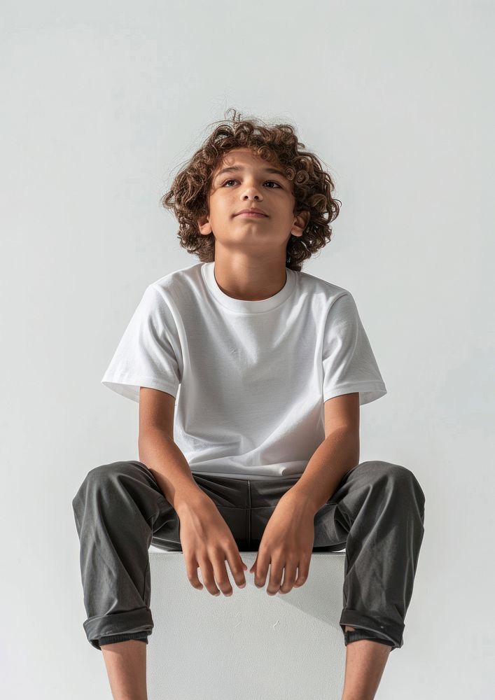 Boy wearing white t shirt mockup clothing sitting apparel.