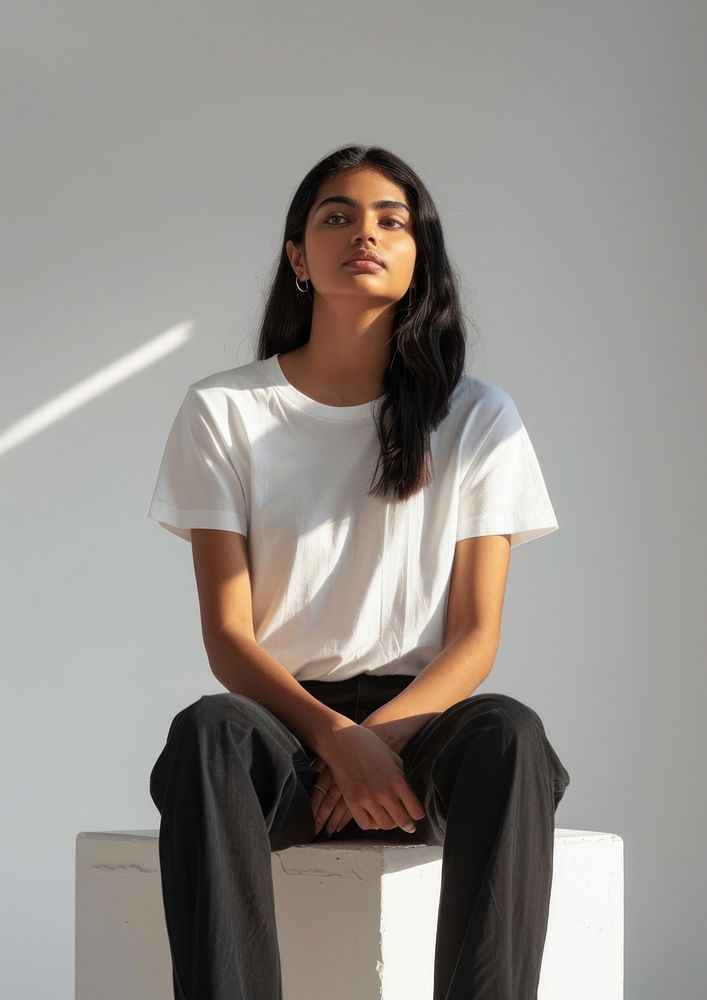 Indian woman wearing white t shirt mockup clothing apparel sitting.