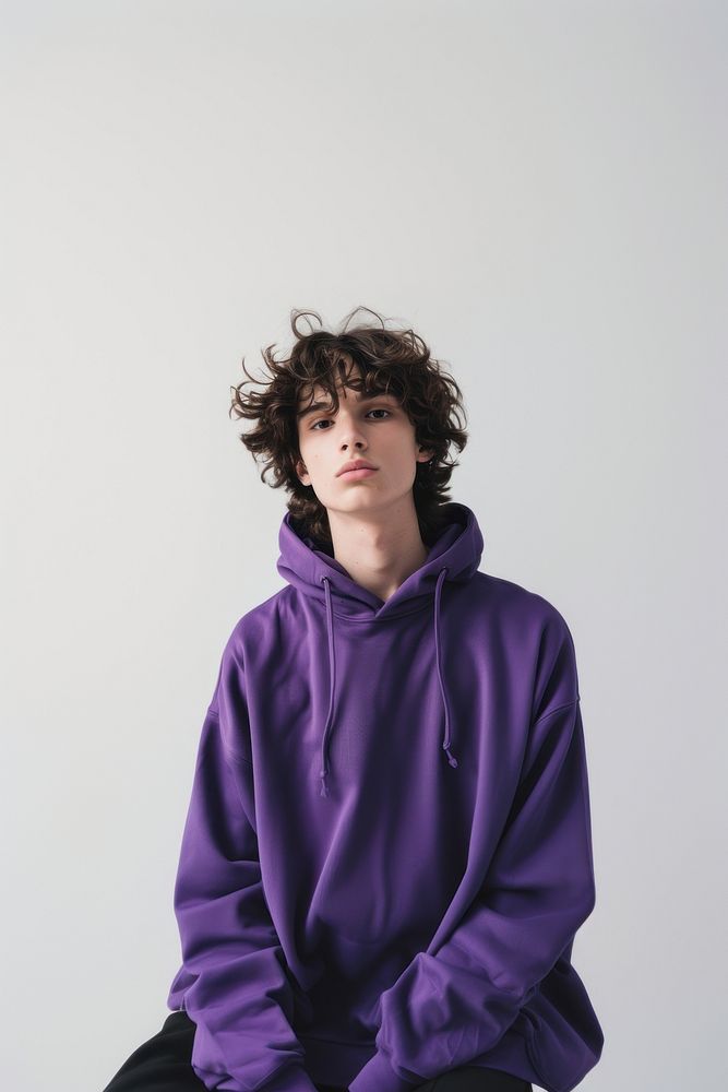 Young man wears blank purple hoodie mockup sweatshirt clothing knitwear.