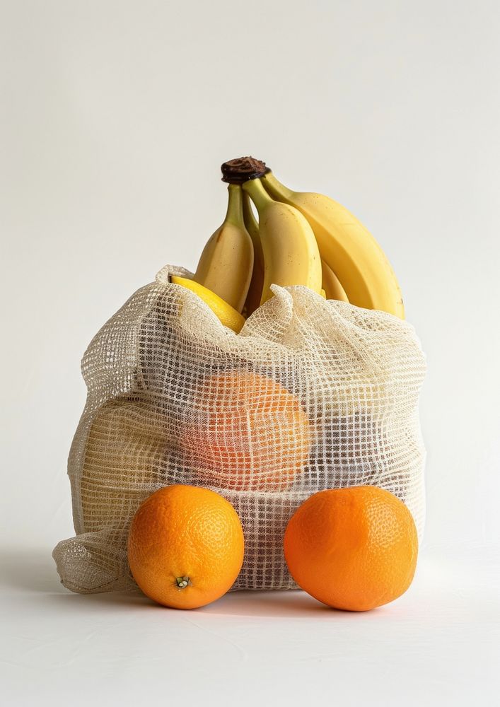 A mesh bag of fruits including orange and banana produce plant food.