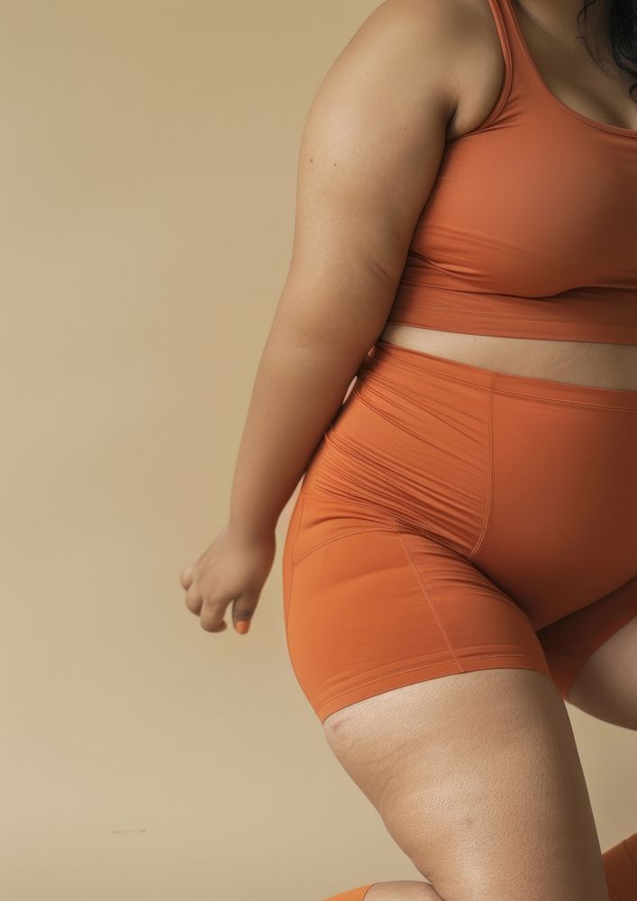 Asian chubby woman in brick orange activewear person human thigh.