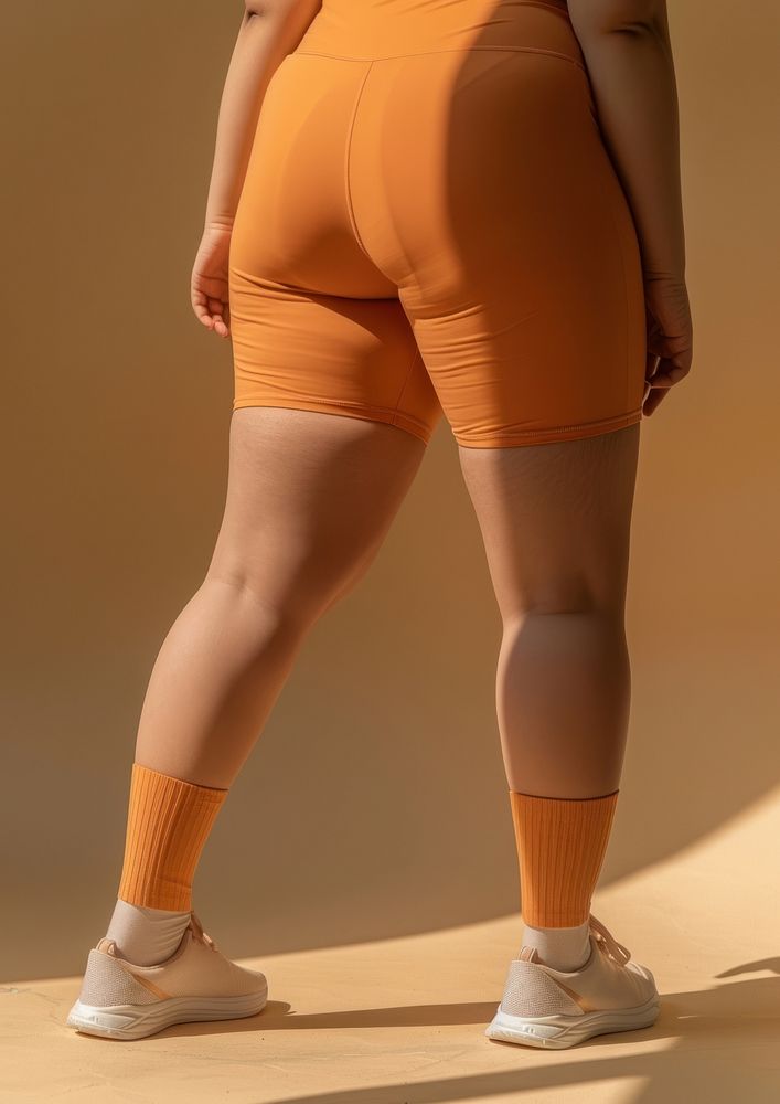 Asian chubby woman in brick orange activewear clothing footwear apparel.