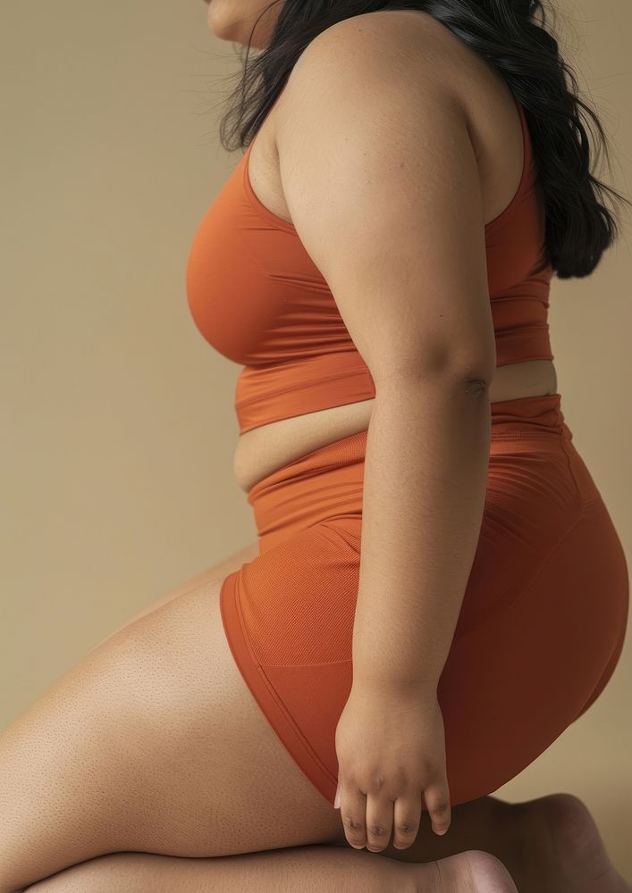 Asian chubby woman in brick orange activewear clothing swimwear apparel.
