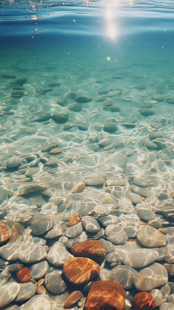 Gravel under the clear water underwater outdoors scenery.
