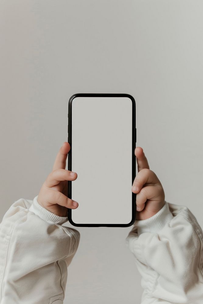 Child holding blank smartphone screen