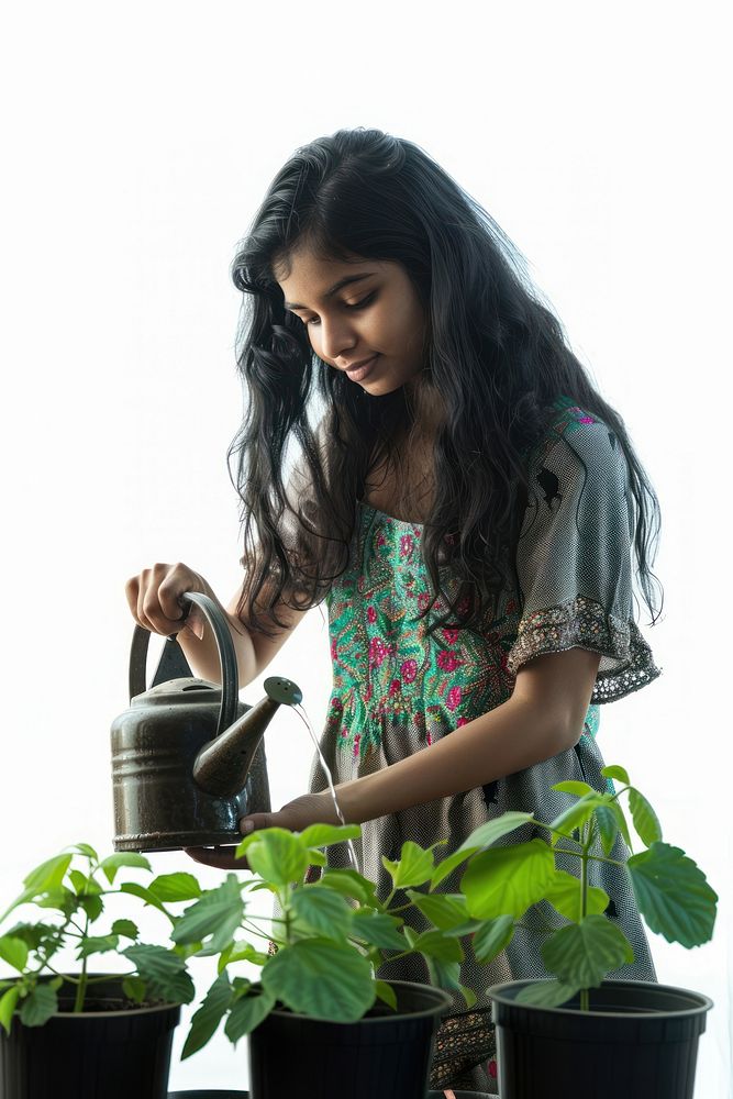 An Indian teenage girl plant tin gardening.