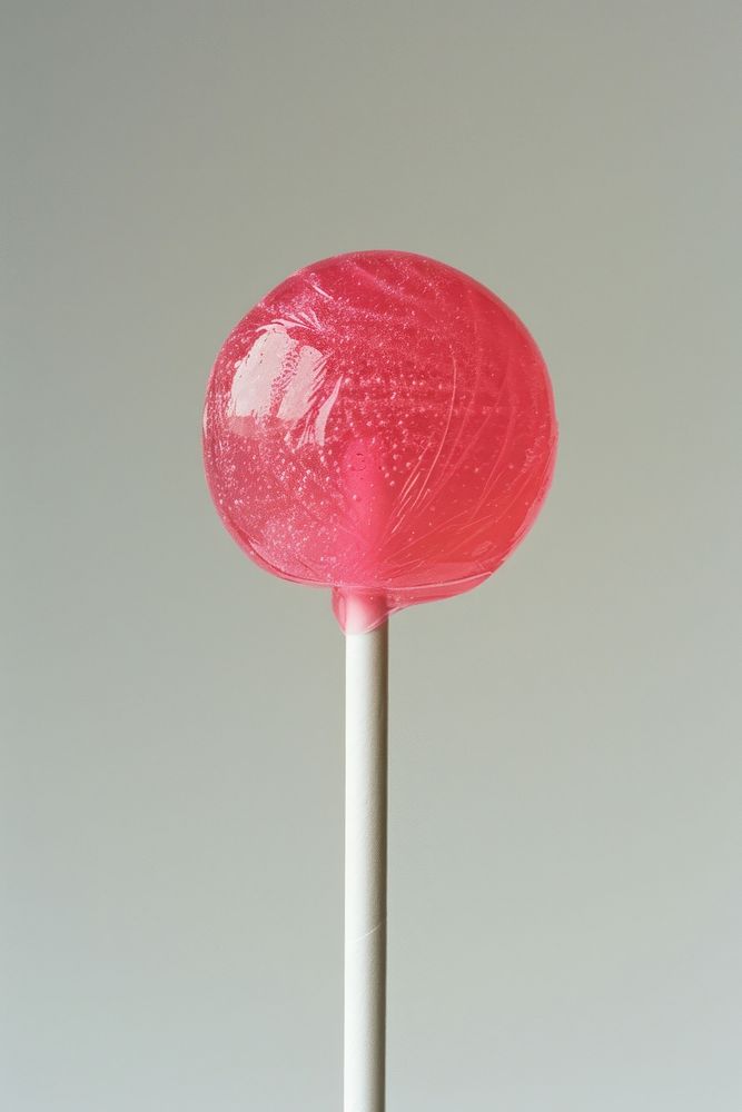 Pink lollipop on white stick