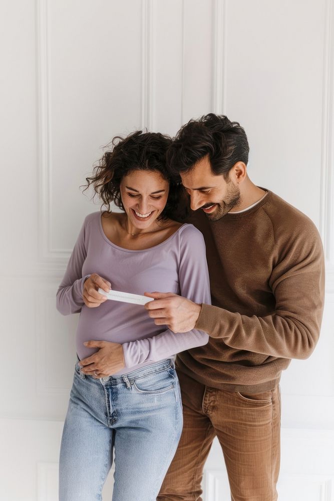 Couple celebrating positive pregnancy test