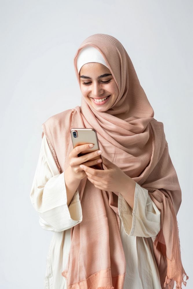 Woman holding mobile phone background clothing smiling.