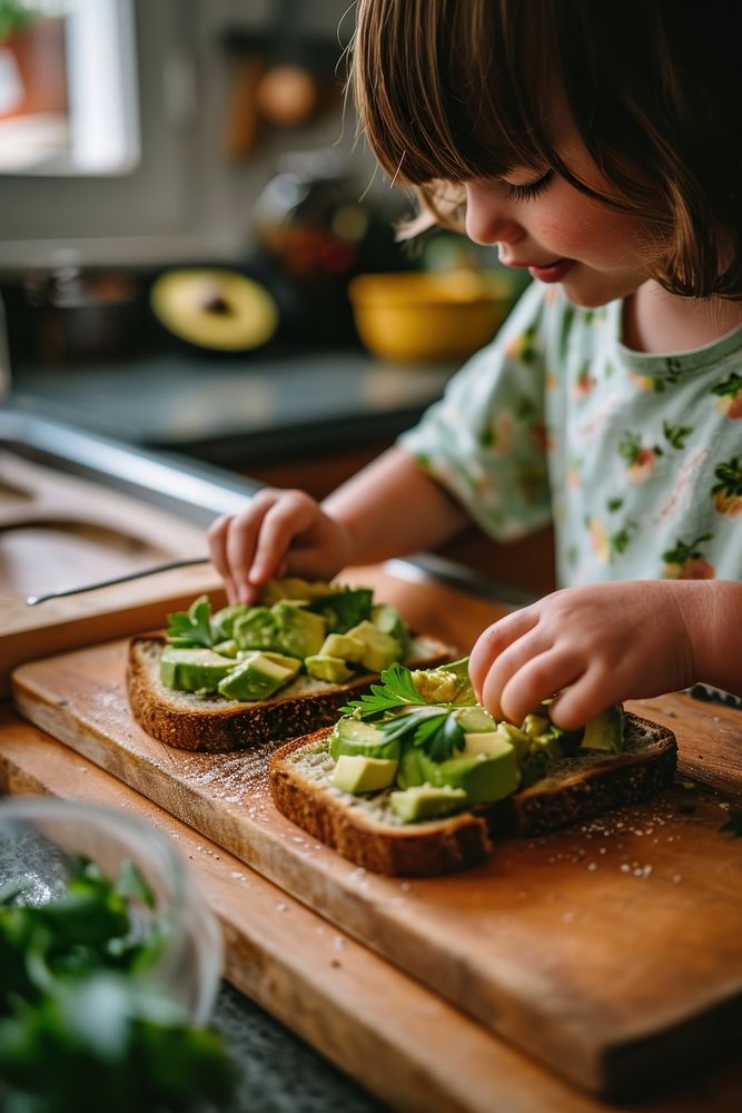 Avocado toasts kitchen child food. AI generated Image by rawpixel.