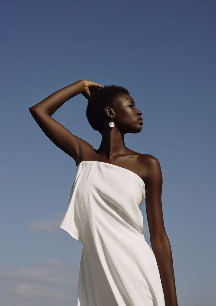 A black teenage woman wearing minimal white dress fashion adult sky.