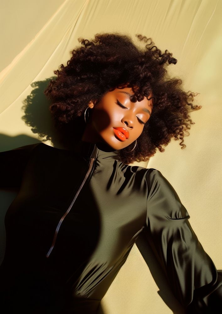 A black woman lay down on the sunlight photography portrait fashion.