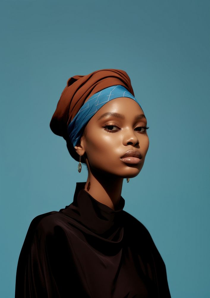 A black woman wearing blue eyeliner with brown headband photography portrait fashion.