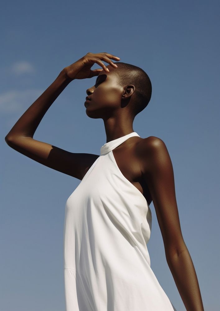 A black woman wearing minimal white dress fashion adult sky.