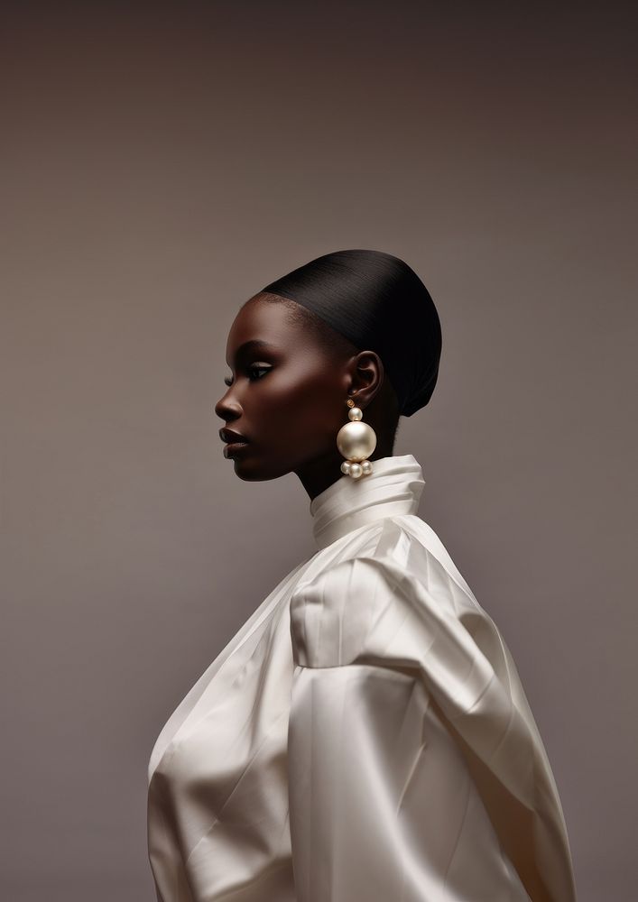 A black woman wearing pearl earring photography portrait jewelry.