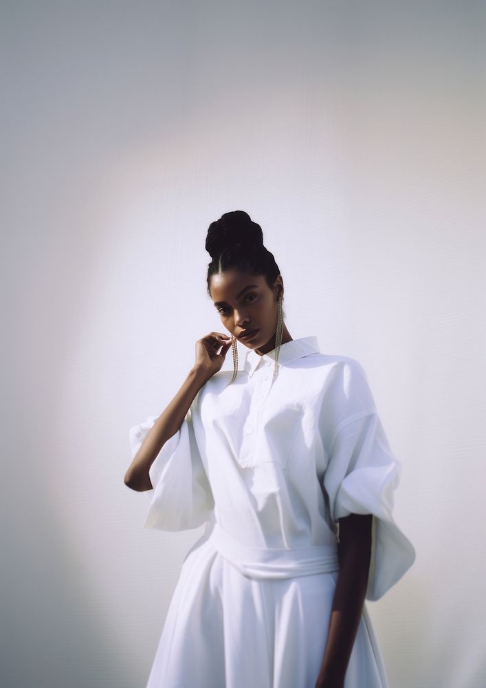 A black woman wearing white modern minimal cloth fashion photography portrait.