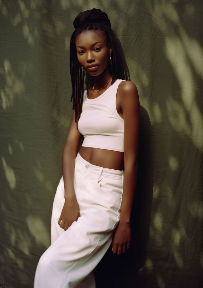 A black woman wearing white modern minimal cloth and jean pant photography portrait fashion.