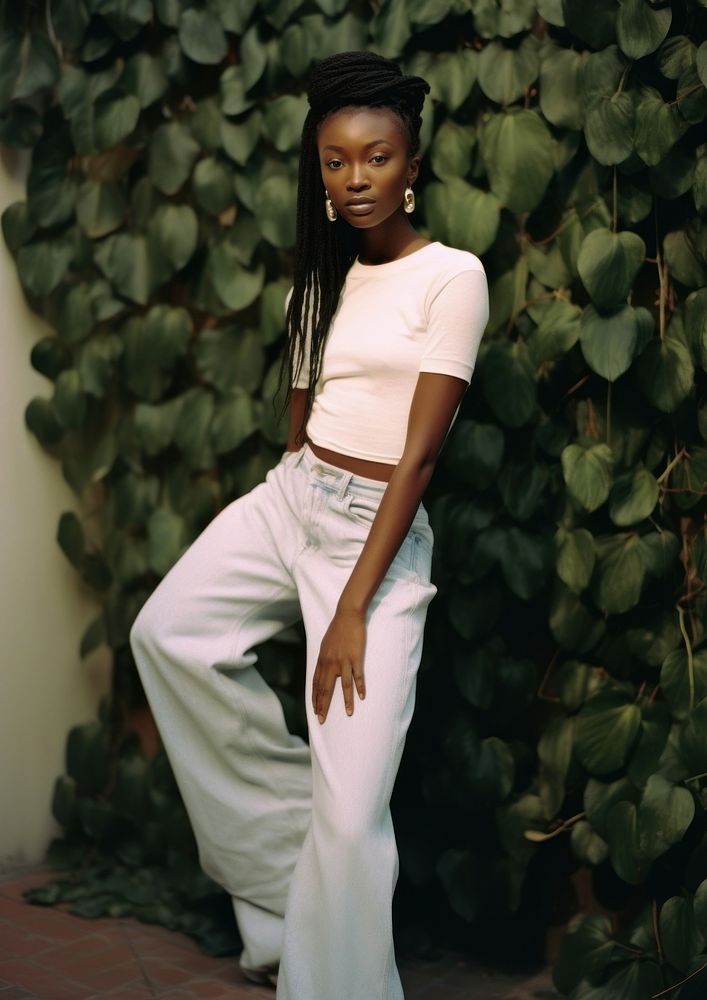 A black woman wearing white modern minimal cloth and jean pant fashion pants architecture.