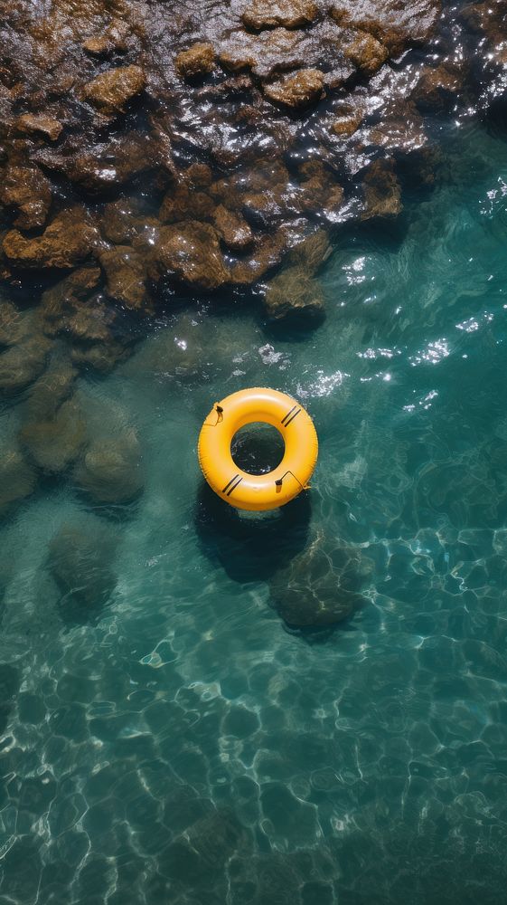 Yellow inflatable ring in the ocean outdoors nature rock.