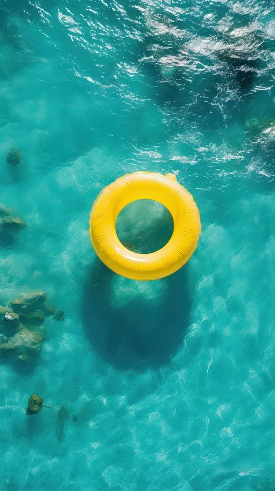 Yellow inflatable ring in the ocean outdoors nature underwater.
