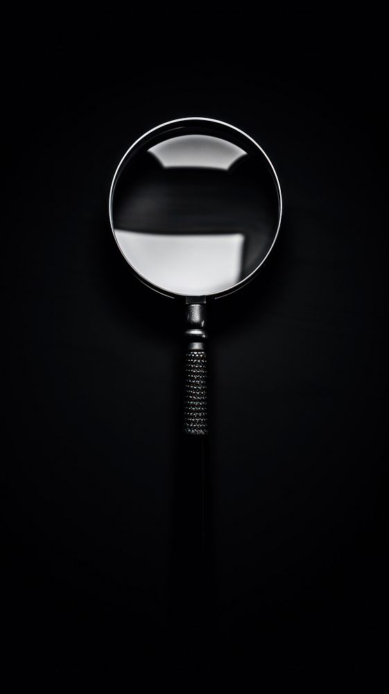Photography of magnifying glass black white reflection.