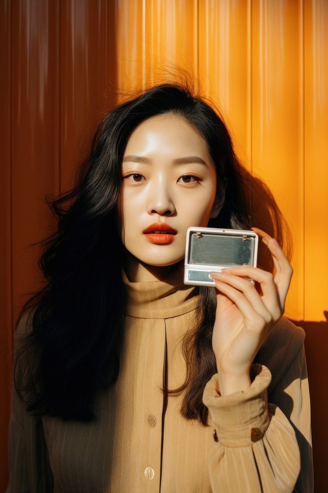 Korean woman holding makeup photography portrait selfie.