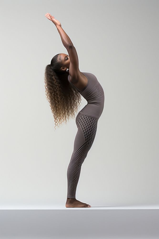 A woman demonstrates a yoga pose dancing sports adult.