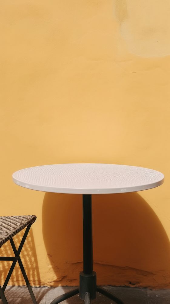 Outdoor table furniture yellow wall. AI generated Image by rawpixel.