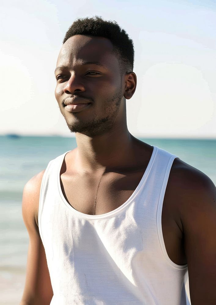 Black man wearing white tank top adult beach contemplation.
