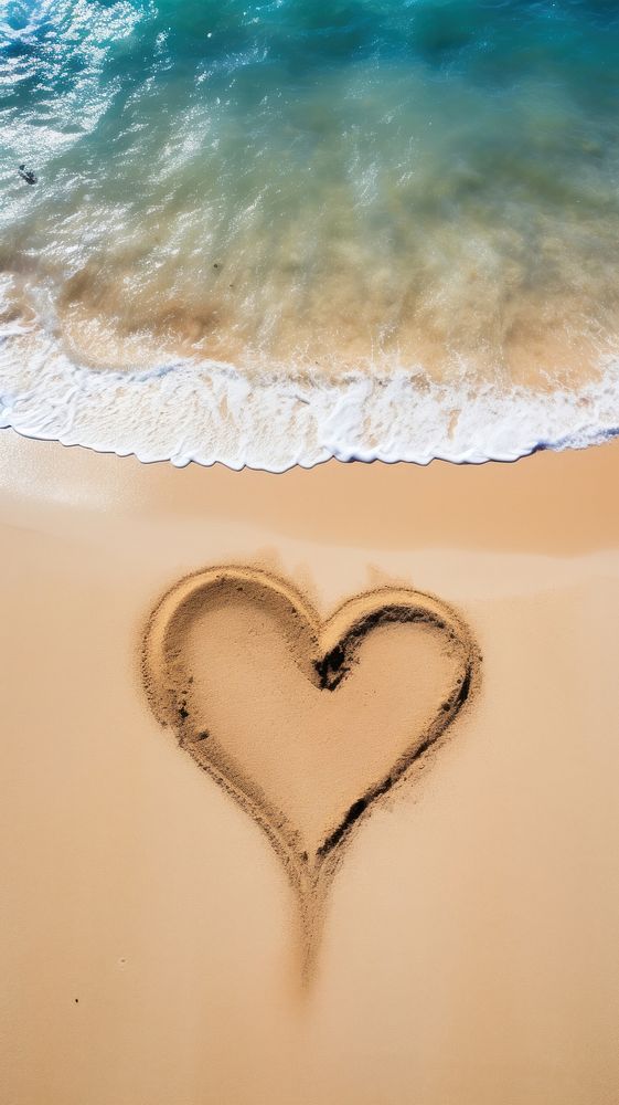  Heart symbol on the sand in the beach nature tranquility sunlight. AI generated Image by rawpixel.