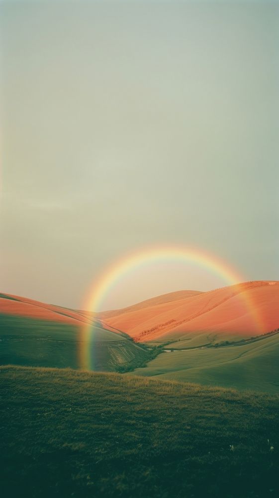 Photography of minimal a rainbow with hillside landscape outdoors horizon nature.