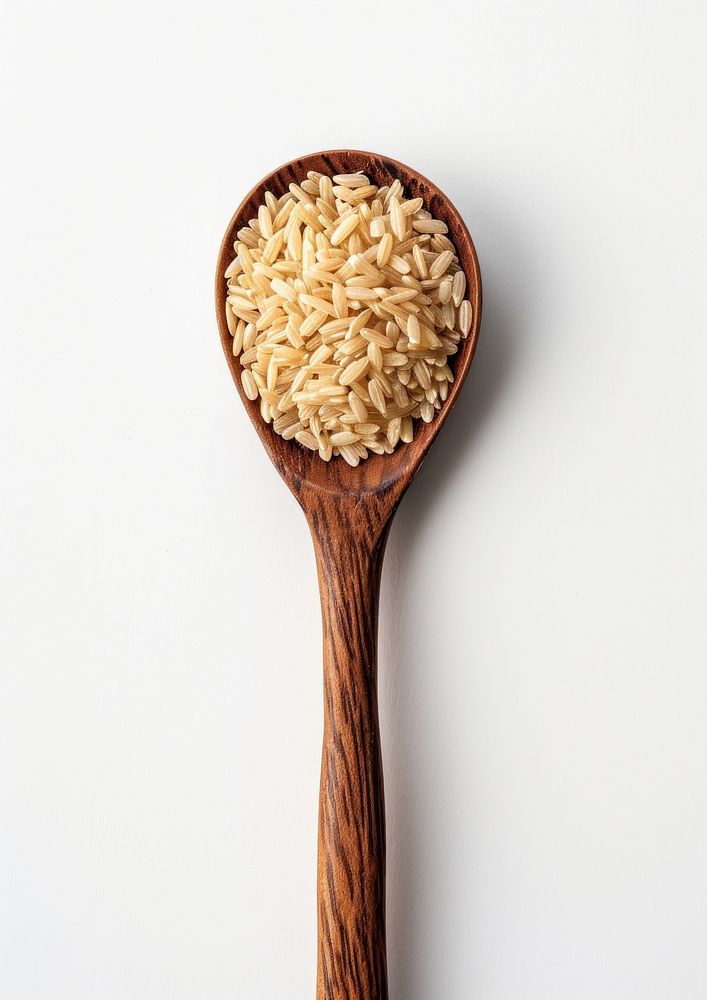 Brown rice in wood spoon food white background ingredient.