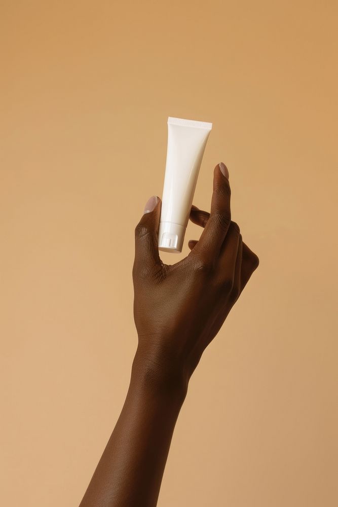 Hand holding cream tube adult simplicity toothpaste.