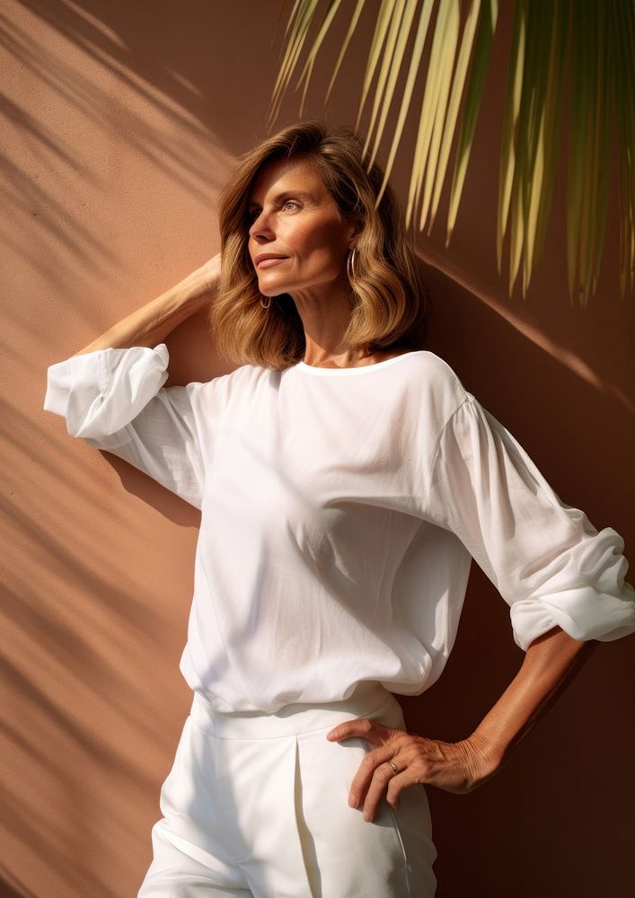 Happy Mature woman wearing white outfit portrait blouse sleeve.
