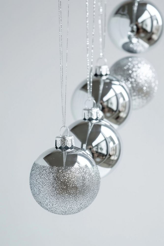 Silver christmas baubles hanging celebration accessories. AI generated Image by rawpixel.