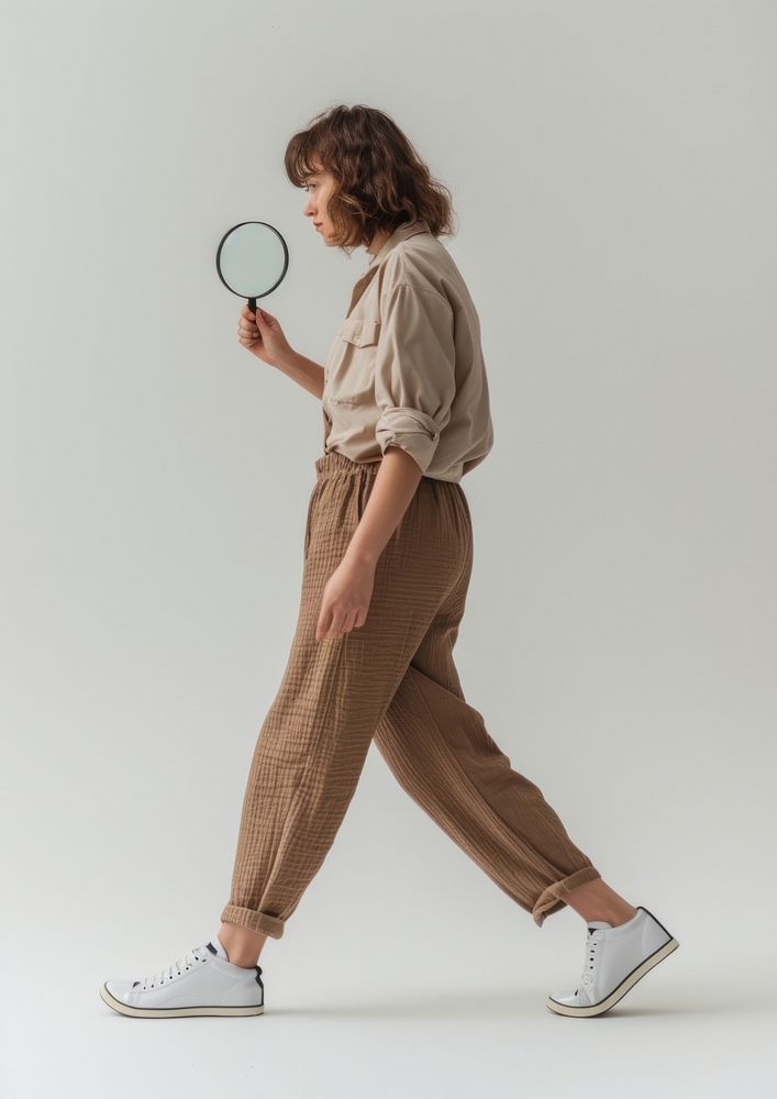 Person holding magnifying glass footwear sports person.