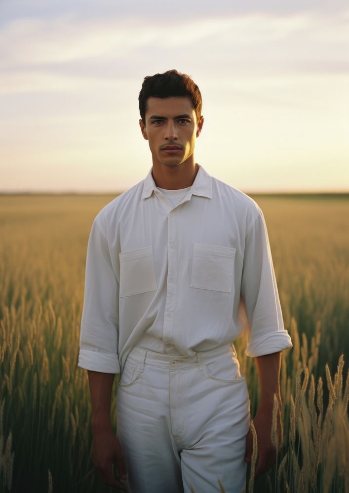 Hispanic man with minimal white shirt standing portrait outdoors.