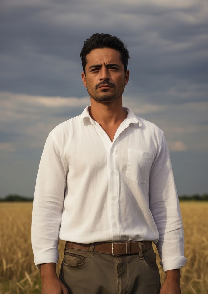 Hispanic man with minimal white shirt standing portrait nature.