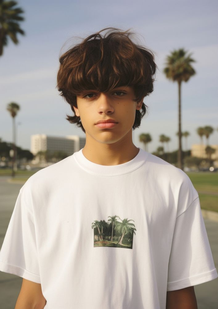 Hispanic young man standing t-shirt hairstyle.